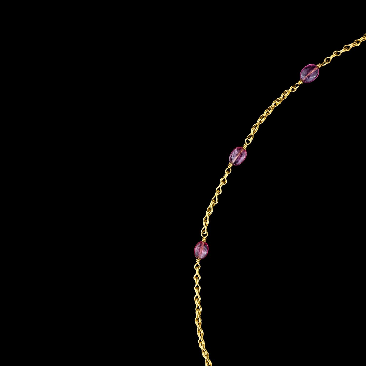 A Hellenistic Gold Eros Pendant — with a modern gold and pink spinel beads chain