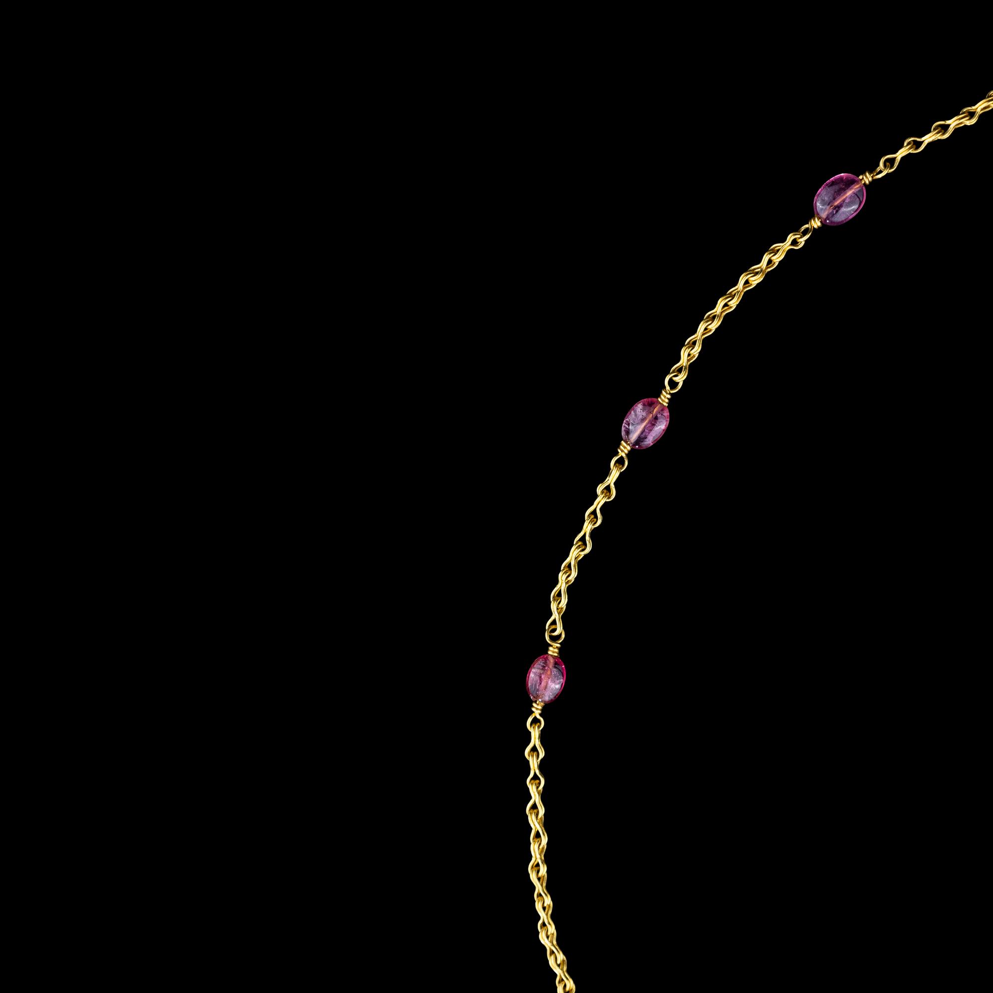A Hellenistic Gold Eros Pendant — with a modern gold and pink spinel beads chain