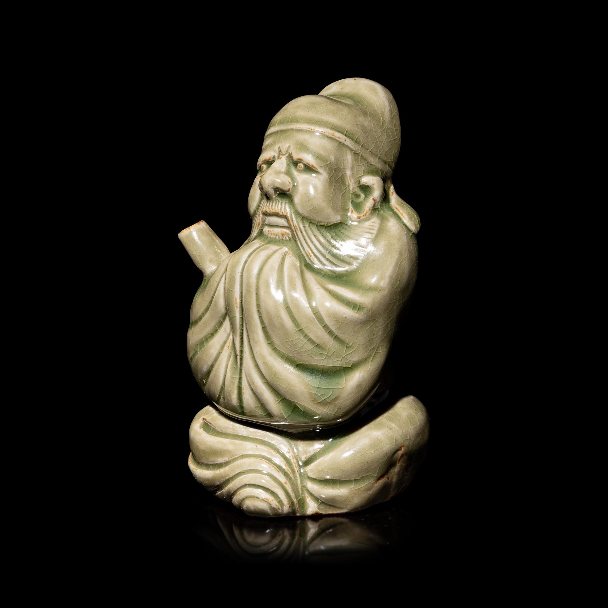 A Chinese Celadon Glazed Porcelain Figure Water Dropper, Yandi — 青釉人物形硯滴