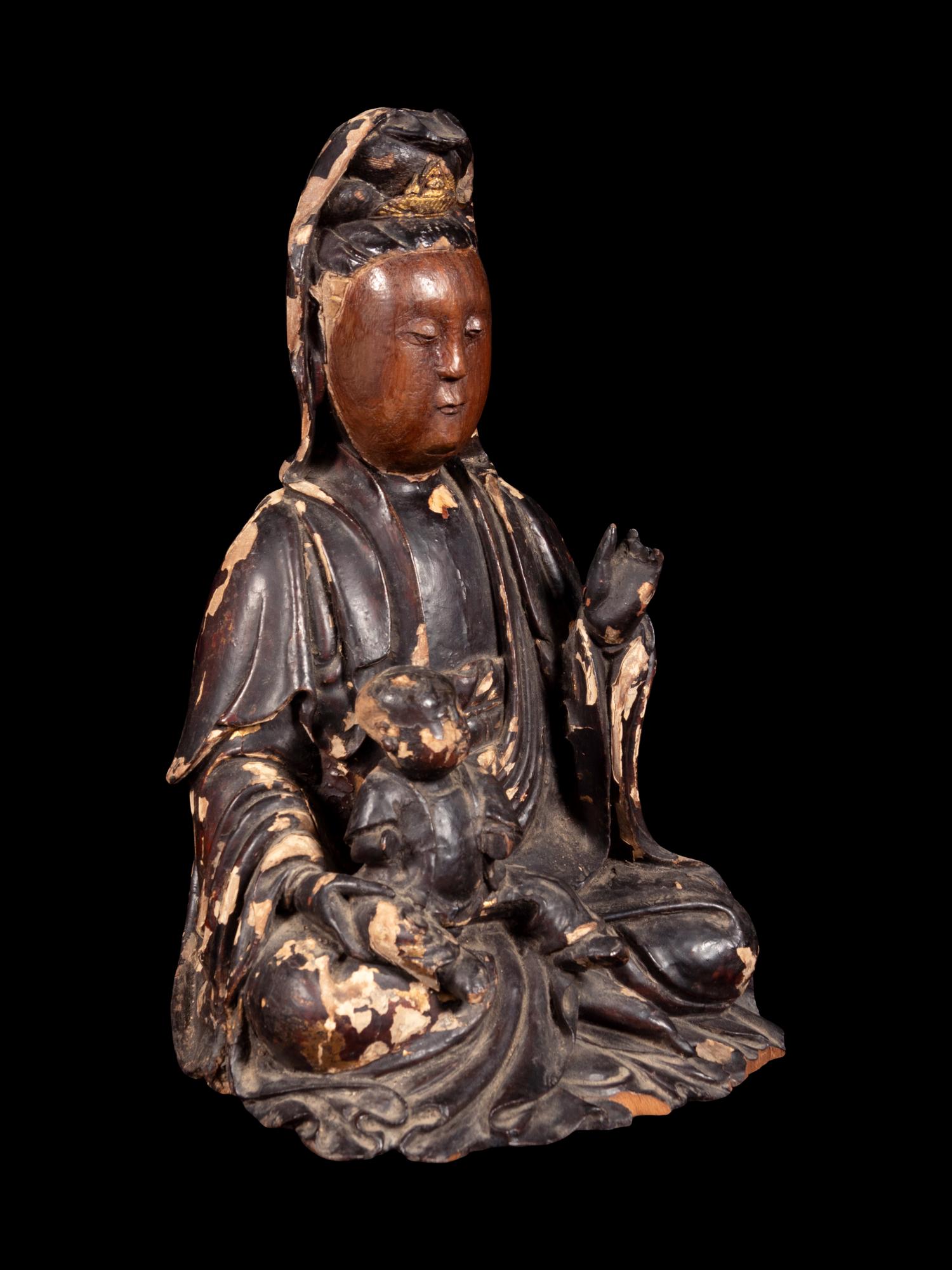 A Gilt Decorated Dark Brown Lacquered Wood Figure of Guanyin and Child