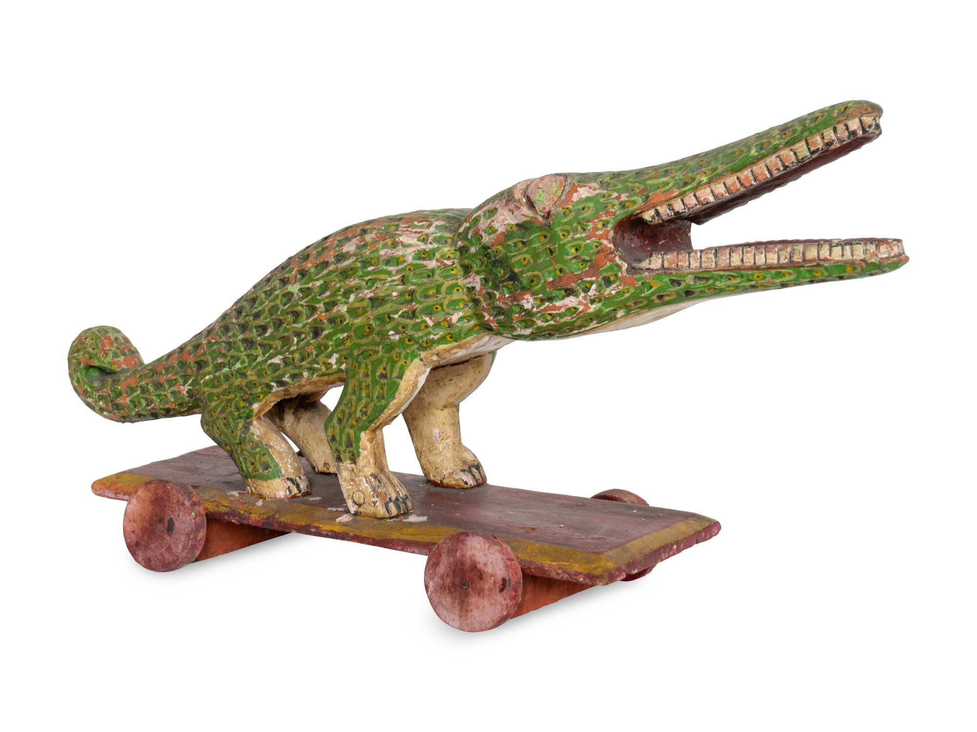 A Folk Art Polychrome Decorated Crocodile Pull-Toy