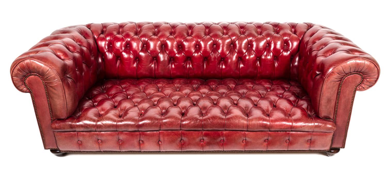 A Red Leather Upholstered Chesterfield Sofa Height 42 x width 84 x depth 36 inches. — 20TH CENTURY