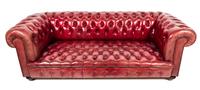 A Red Leather Upholstered Chesterfield Sofa Height 42 x width 84 x depth 36 inches. — 20TH CENTURY
