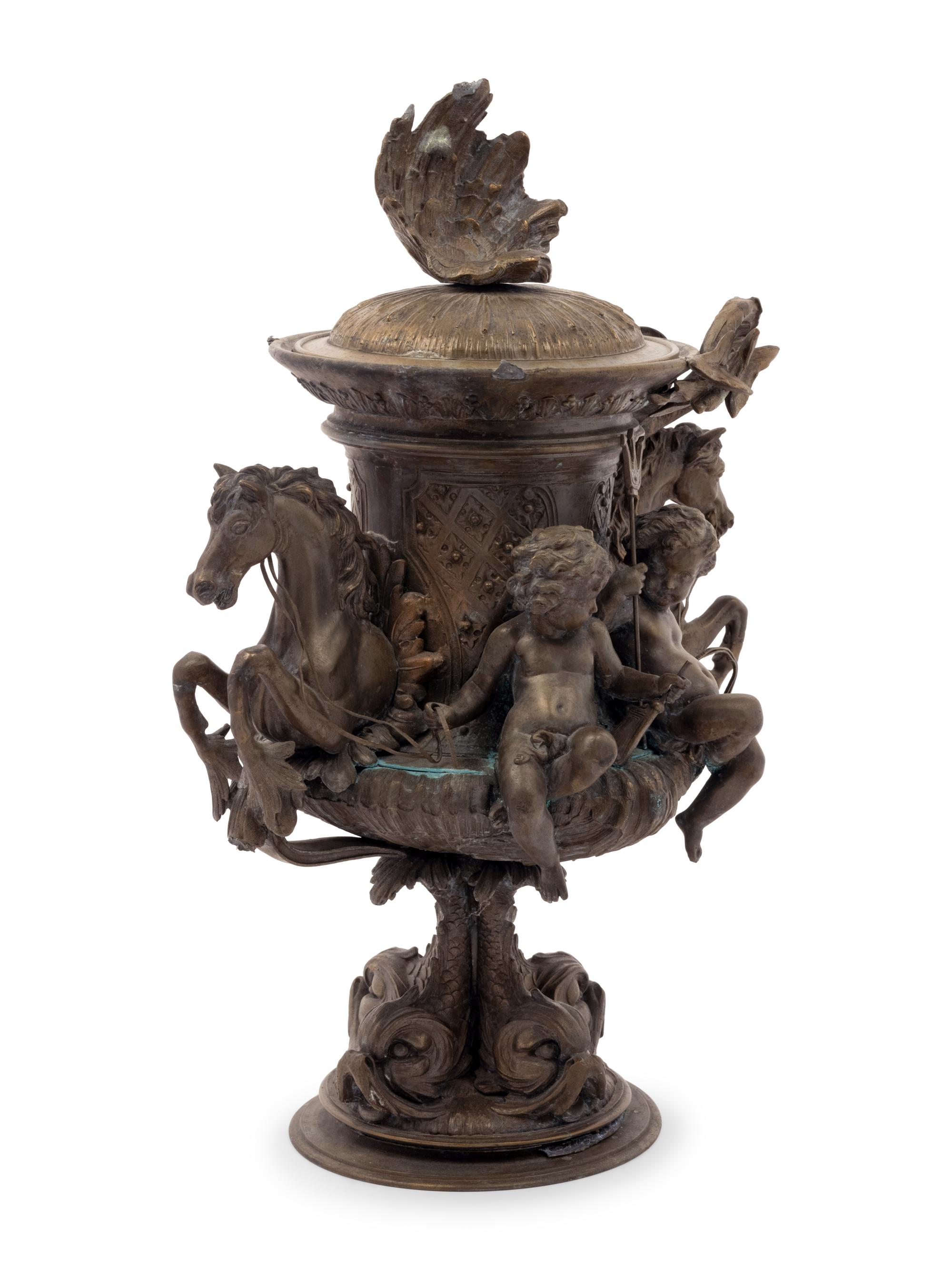 A Continental Cast Metal Urn with Putti and Hippocampi