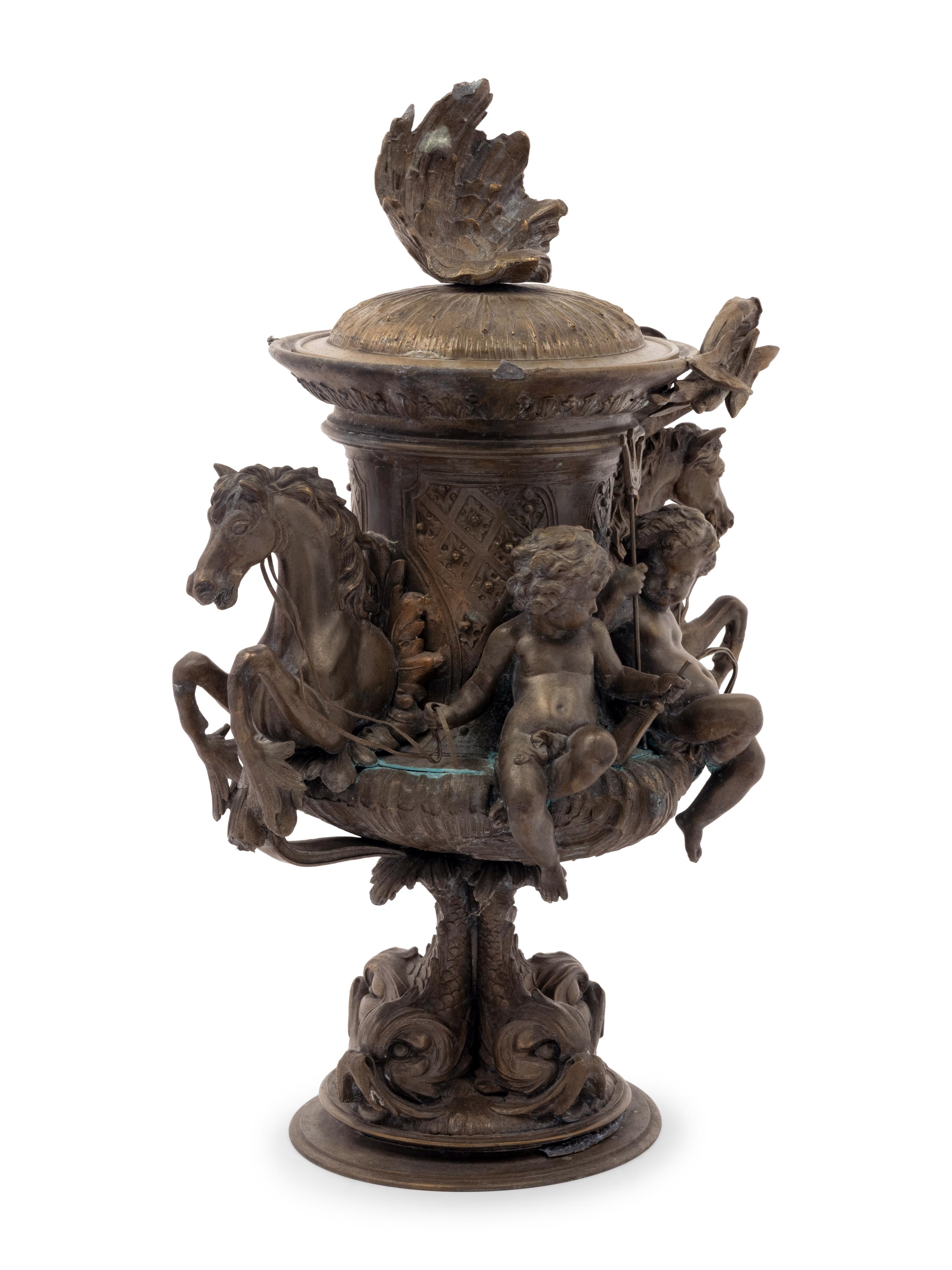A Continental Cast Metal Urn with Putti and Hippocampi