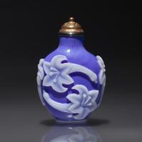 A Chinese White Overlaid Blue Glass Snuff Bottle, Qing Dynasty, 18th Century — 清中期 寶石藍地套白料萱花紋鼻煙壺