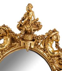 A Pair of Italian Baroque Carved Giltwood Oval Mirrors — 19TH CENTURY