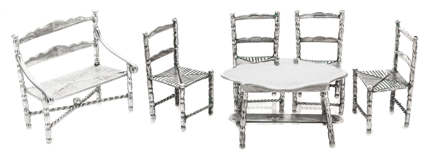 A Dutch Silver Six-Piece Dining Room Set, , comprising four chairs, a bench and a table with a cartouche form top, each raised on turne