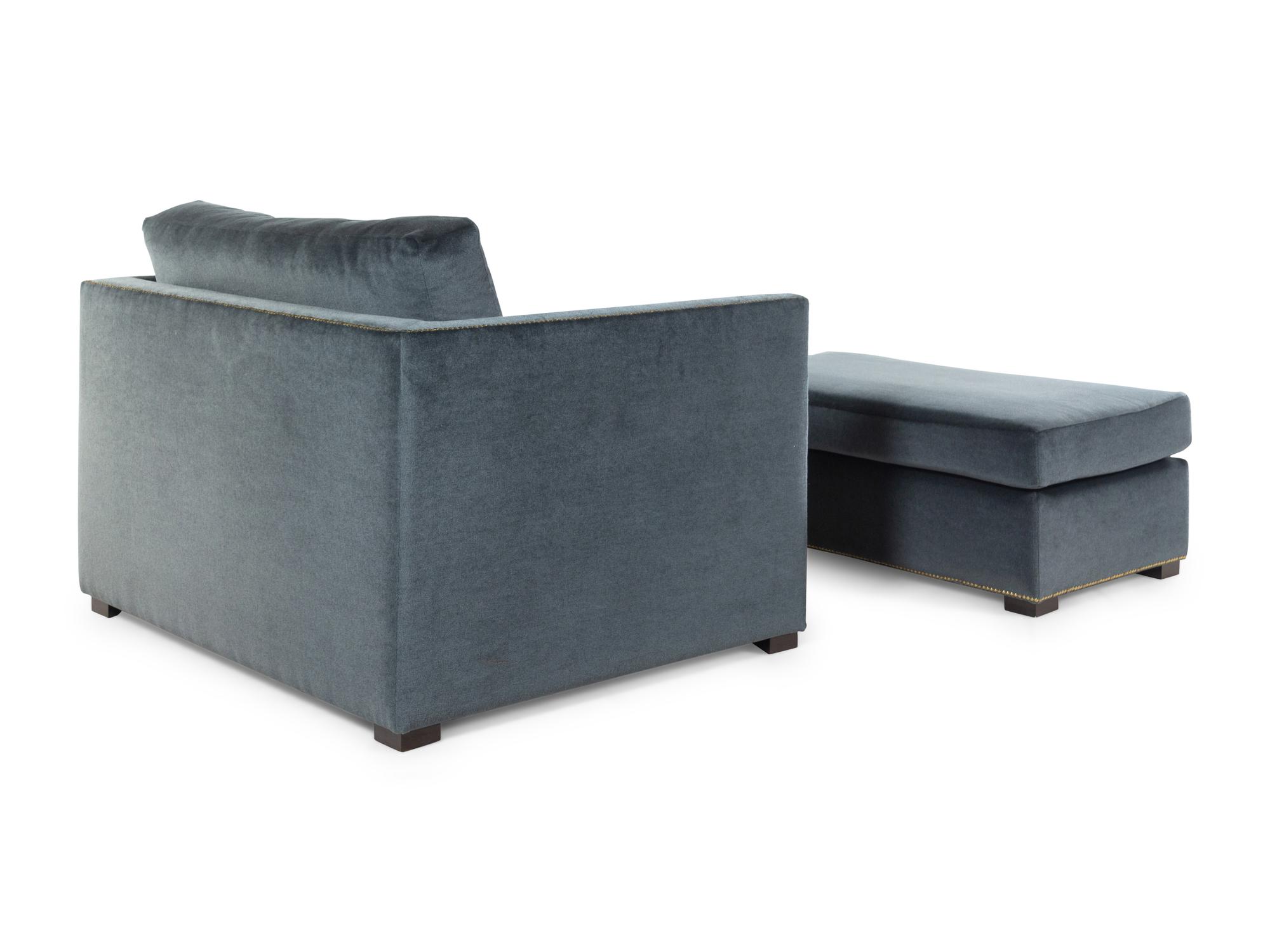 A Contemporary Velvet-Upholstered Armchair and Ottoman