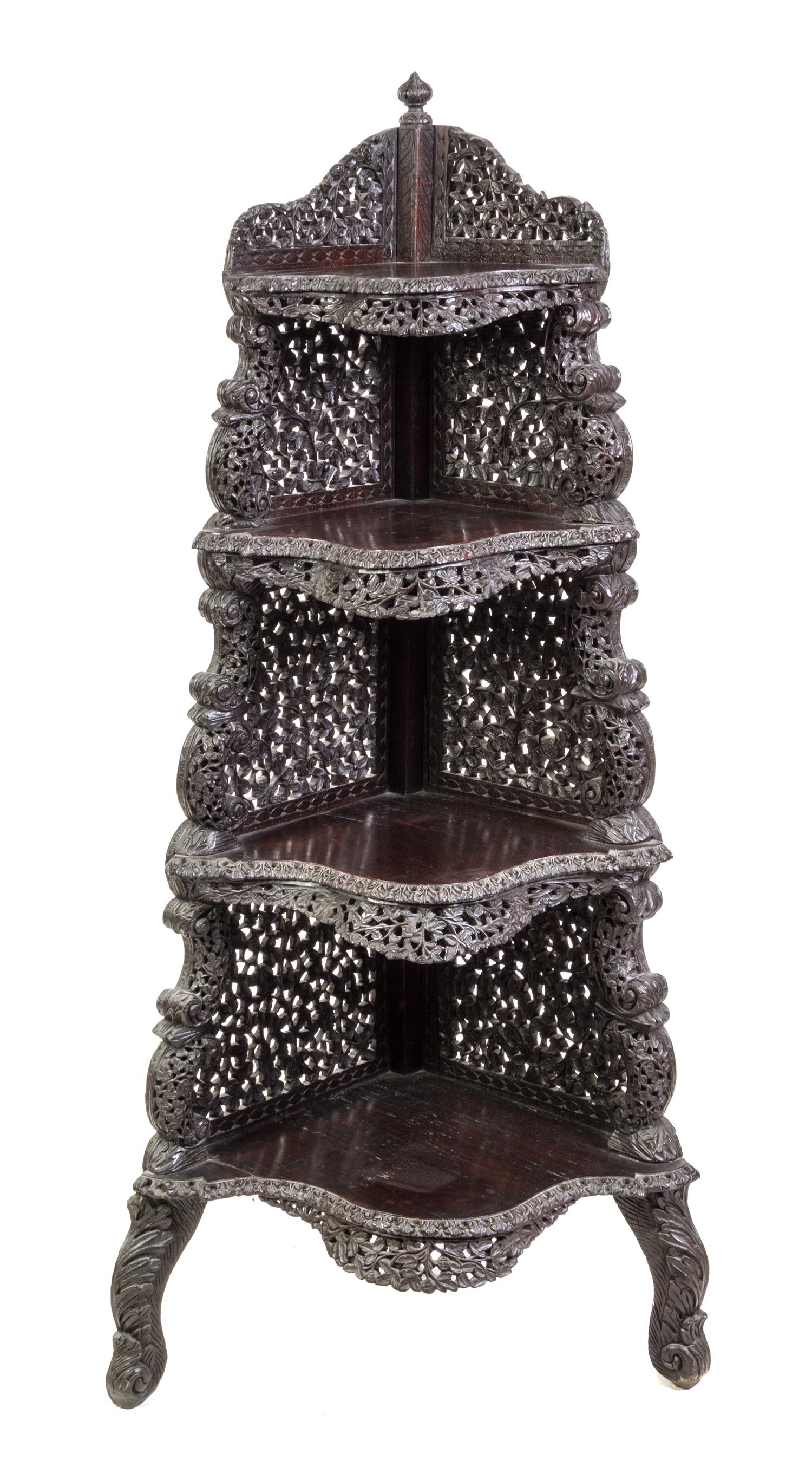 An Anglo-Indian Carved Hardwood Corner Etagere Height 58 1/2 x width 19 x depth 19 inches. — LATE 19TH/EARLY 20TH CENTURY