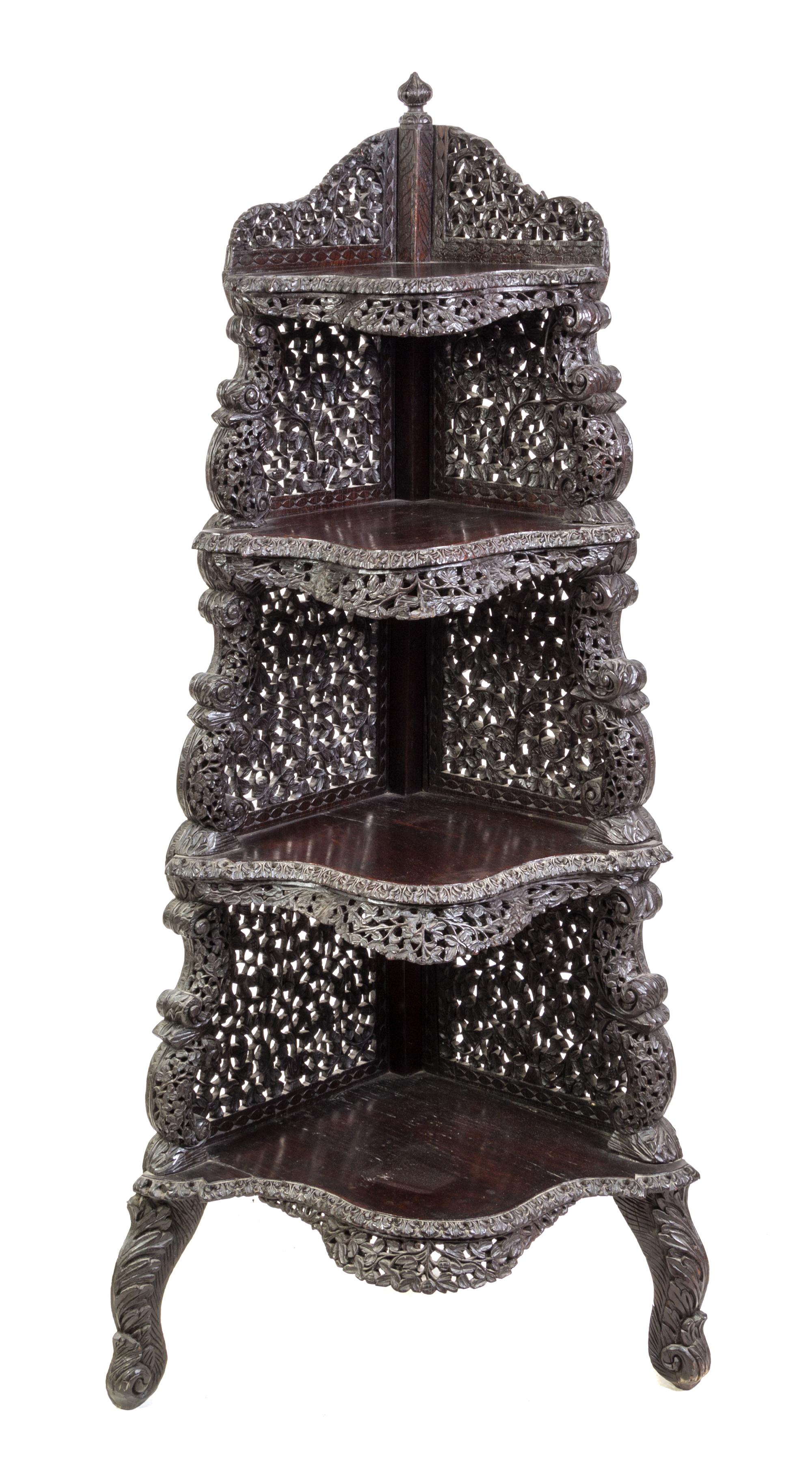 An Anglo-Indian Carved Hardwood Corner Etagere Height 58 1/2 x width 19 x depth 19 inches. — LATE 19TH/EARLY 20TH CENTURY