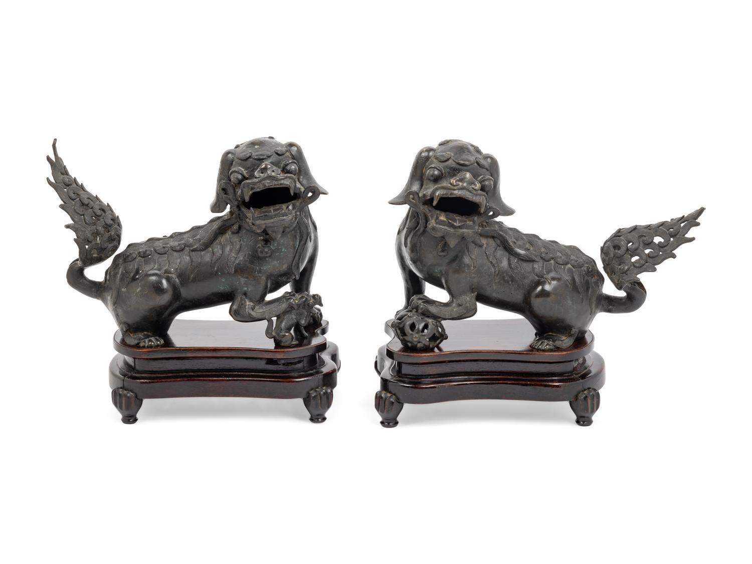A Pair of Chinese Bronze Buddhistic Lions with Wood Stands