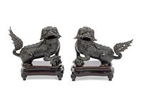 A Pair of Chinese Bronze Buddhistic Lions with Wood Stands