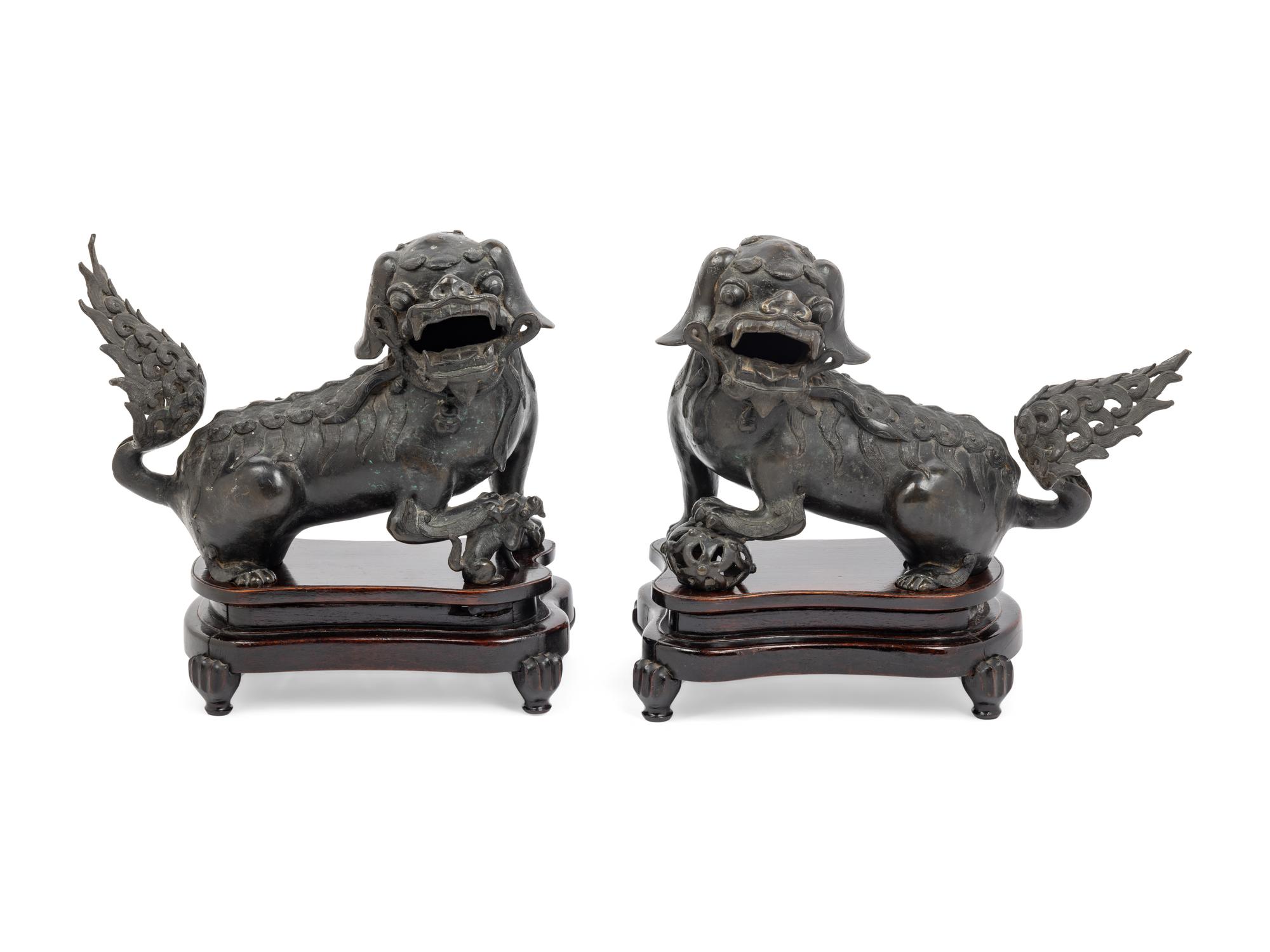 A Pair of Chinese Bronze Buddhistic Lions with Wood Stands