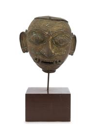 An Indian Bronze Head of a Deity 18TH/19TH CENTURY Height overall 14 inches. — 18TH/19TH CENTURY