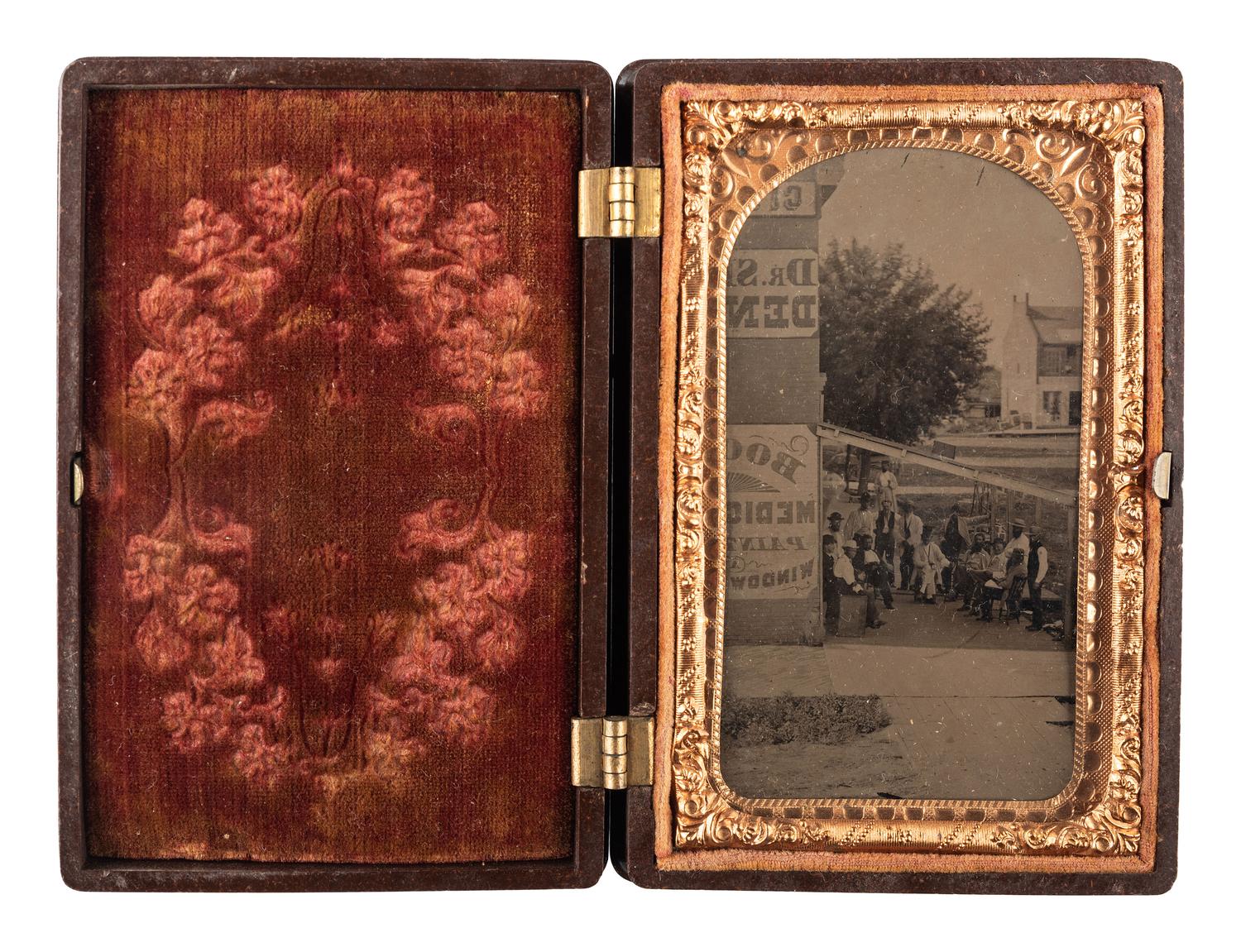[EARLY PHOTOGRAPHY - OUTDOOR SCENES]. A CDV-sized tintype of a group of men on the porch of a large building, including possible African American subjects.