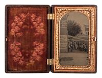 [EARLY PHOTOGRAPHY - OUTDOOR SCENES]. A CDV-sized tintype of a group of men on the porch of a large building, including possible African American subjects.