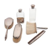 comprising a shoe horn, five brushes, two combs, a button hook, two perfume bottles and two boxes, 13 items total.