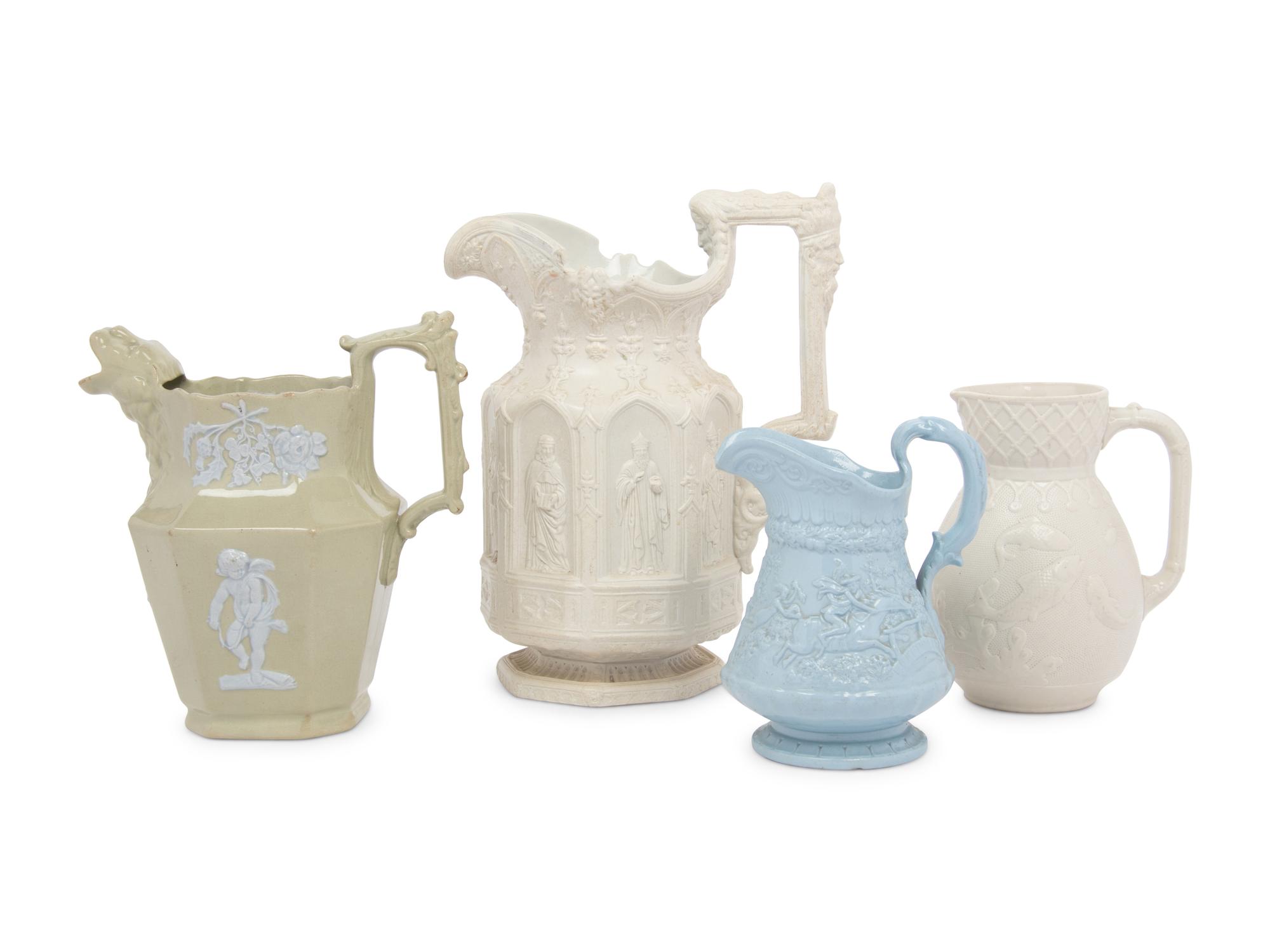 Four English Molded and Glazed Pottery Pitchers