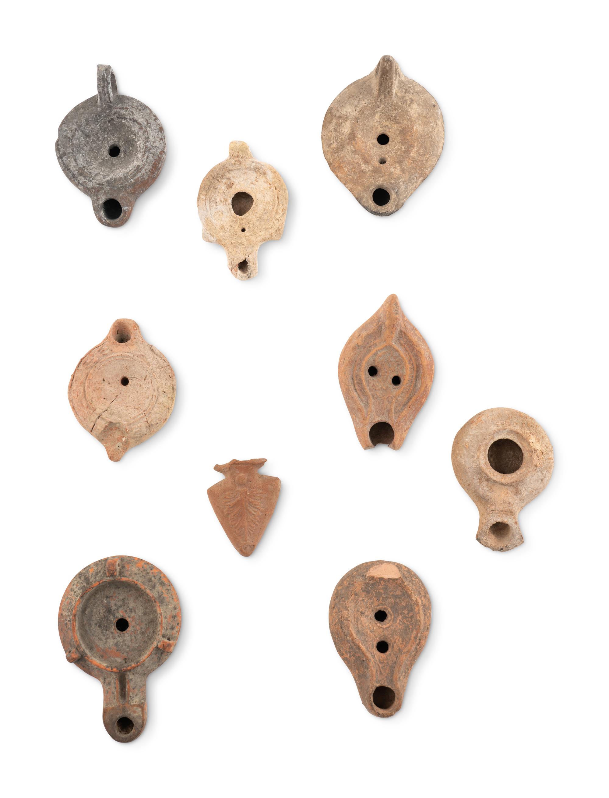 A Group of Seventeen Roman Oil Lamps and Lamp Handles