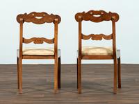 A Set of Six Classical Carved Walnut Dining Chairs