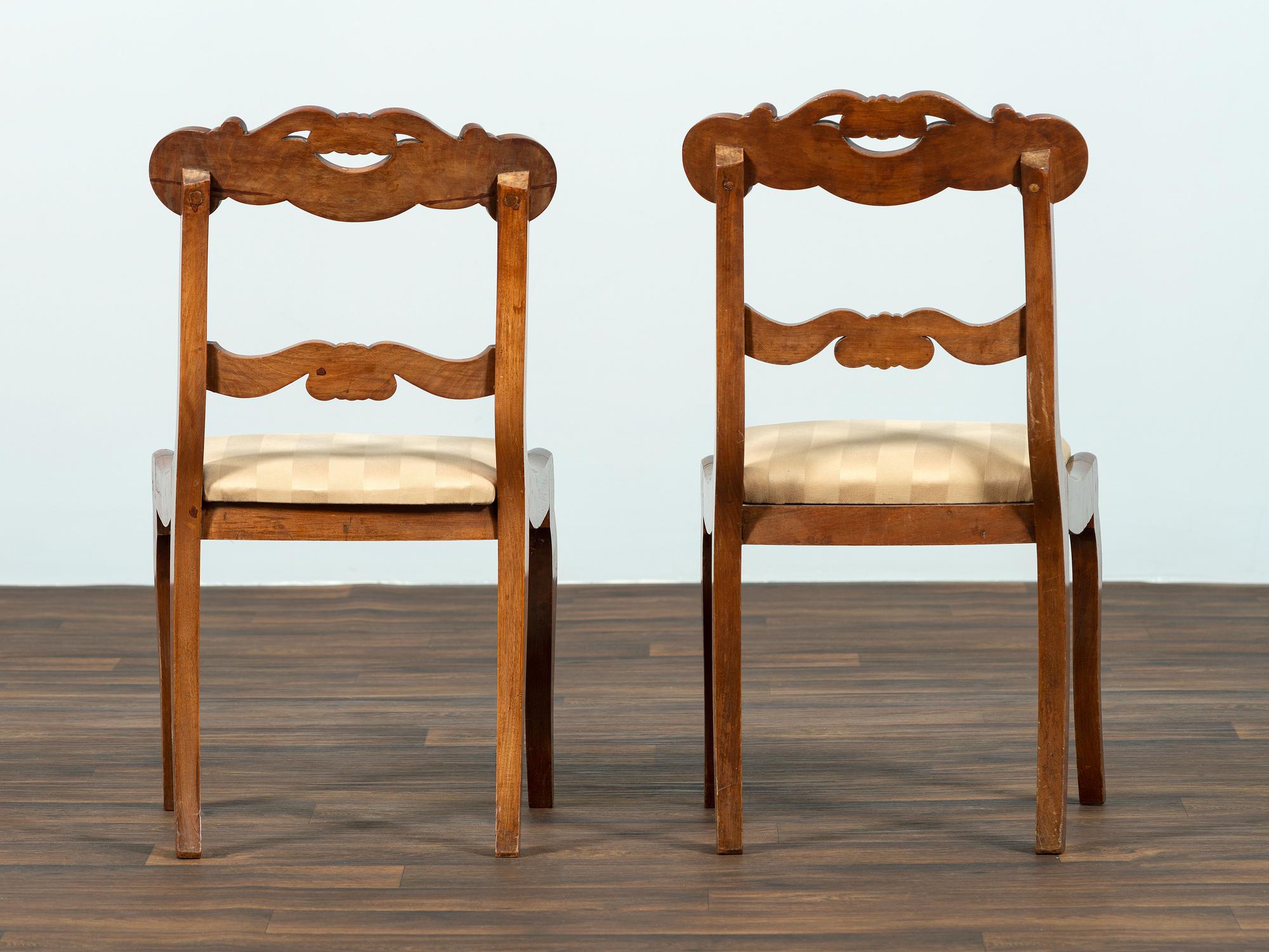 A Set of Six Classical Carved Walnut Dining Chairs