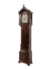 A Federal Carved and Figured Mahogany Tall Case Clock