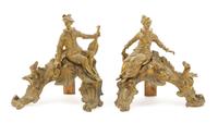 A Pair of French Gilt Bronze Chenets Height 12 3/4 x width of wider 13 inches. — LATE 19TH CENTURY