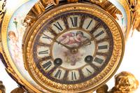 A Louis XVI Style Gilt Bronze and Sèvres Style Porcelain Clock Garniture