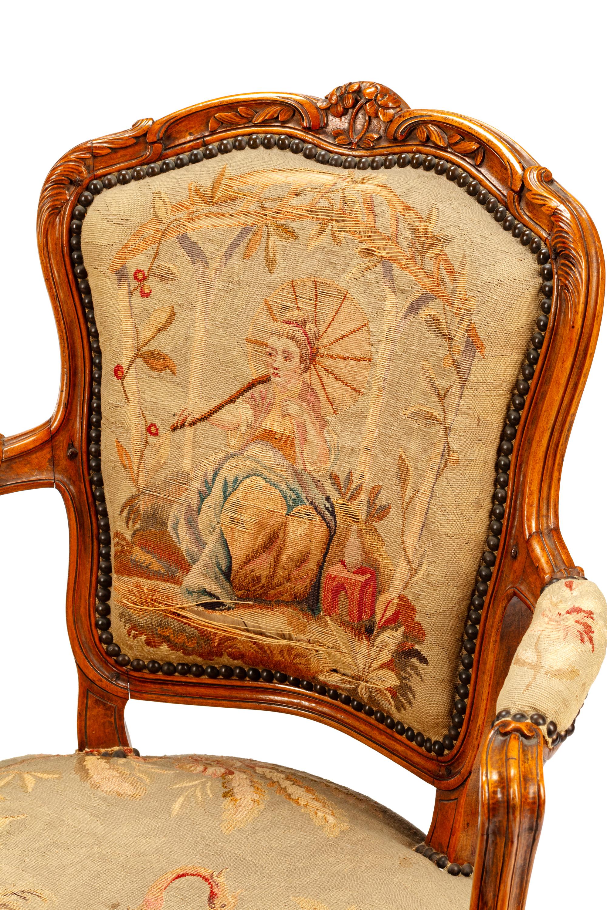 A Pair of Louis XV Tapestry-Upholstered Walnut Fauteuils