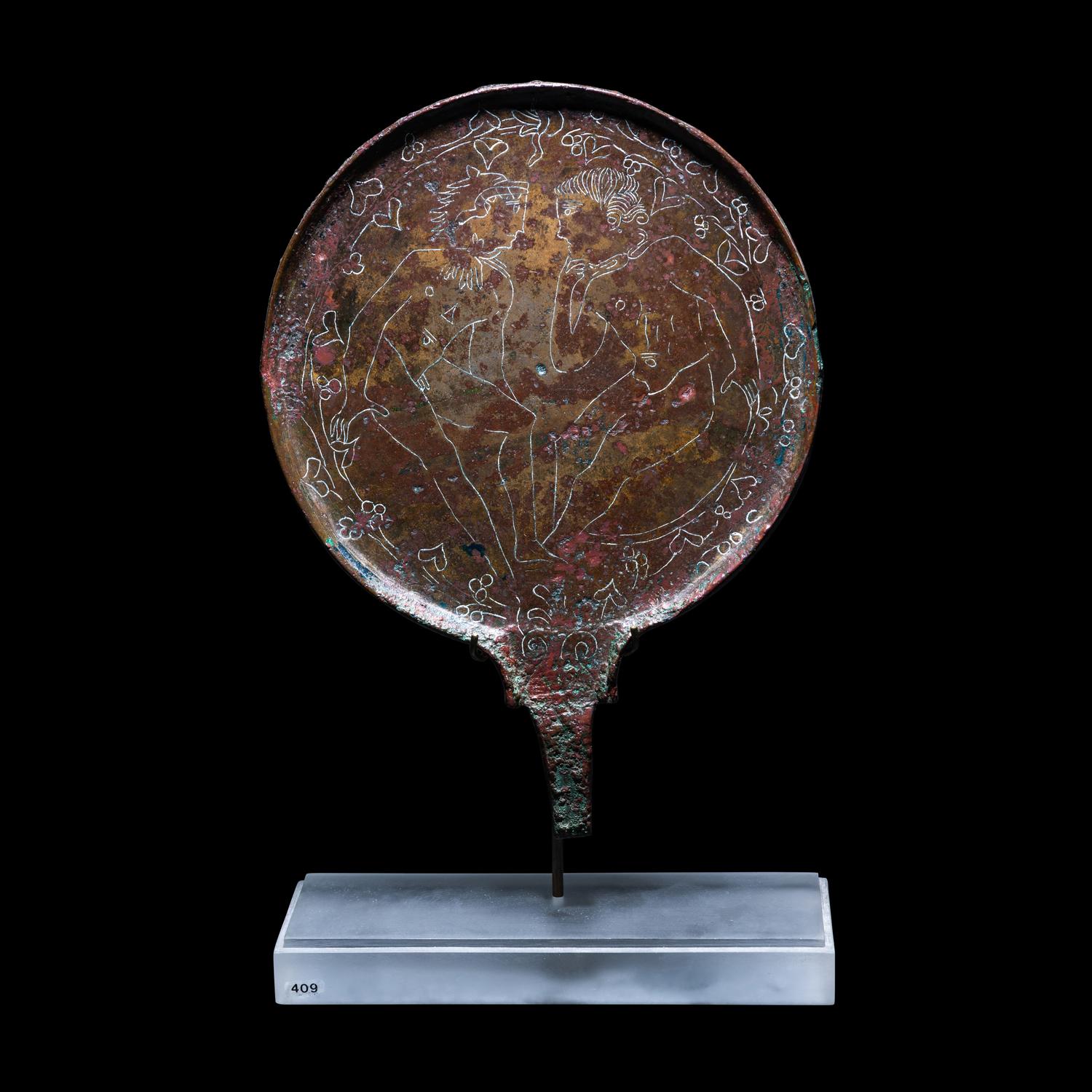 An Etruscan Bronze Mirror with Incised Scene of Hercules and Apollo