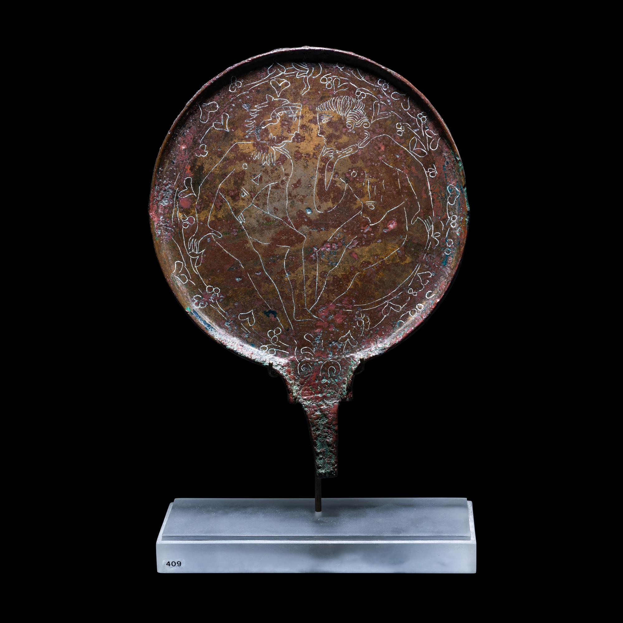 An Etruscan Bronze Mirror with Incised Scene of Hercules and Apollo