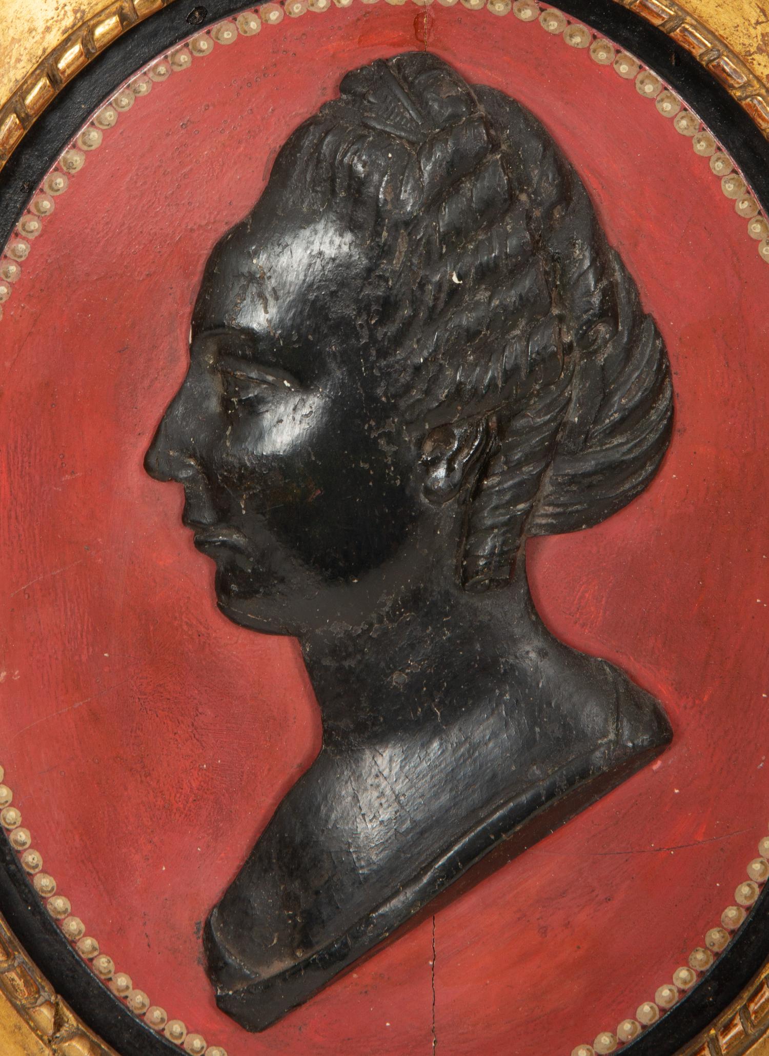 A Pair of Giltwood Framed Ebonized Relief Portrait Plaques of French Nobility, 18th Century