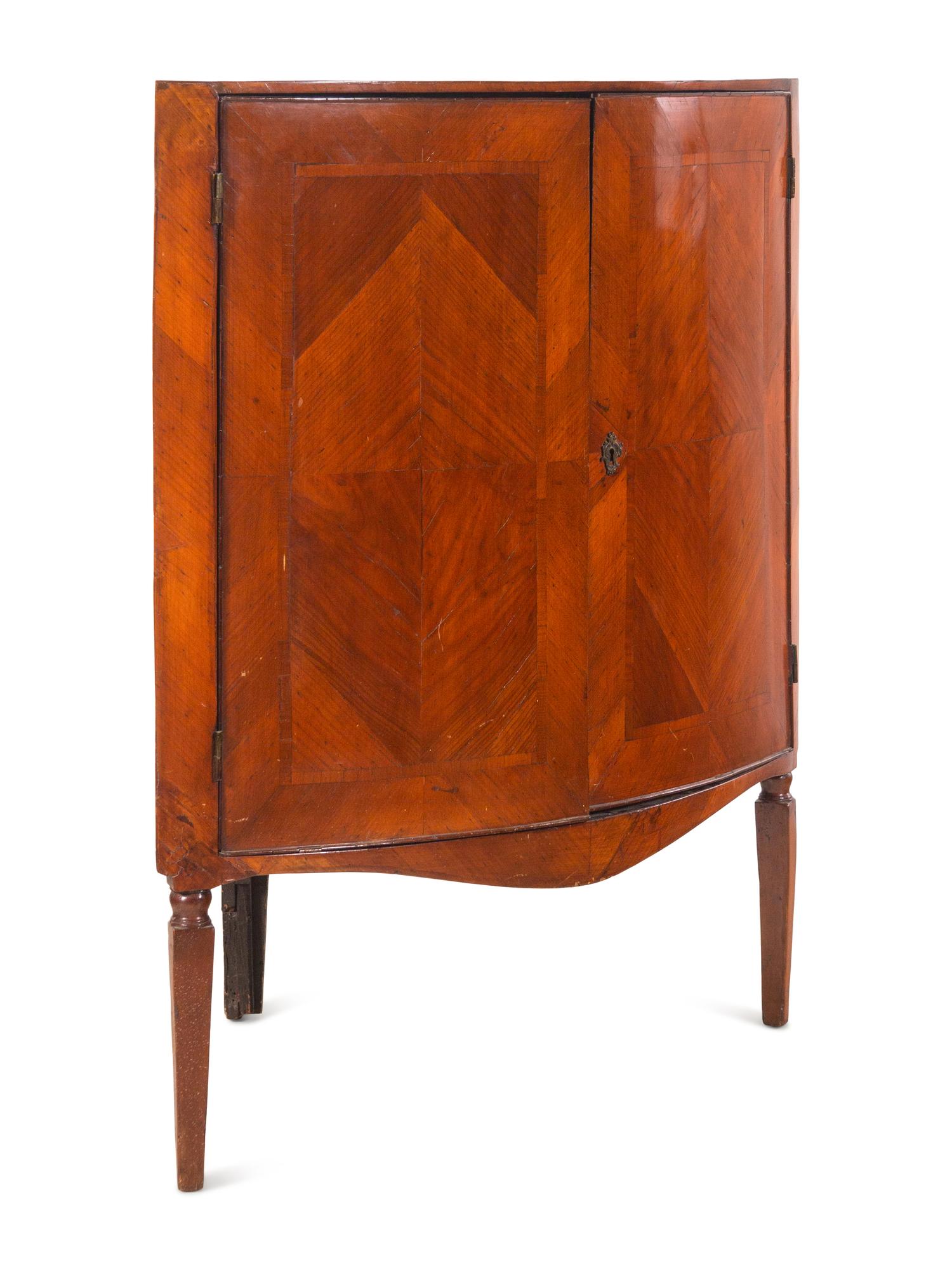 A Continental Bookmatch Veneered Corner Cabinet