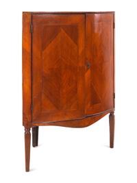A Continental Bookmatch Veneered Corner Cabinet