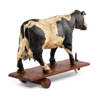 An Early Carved Cow Pulltoy