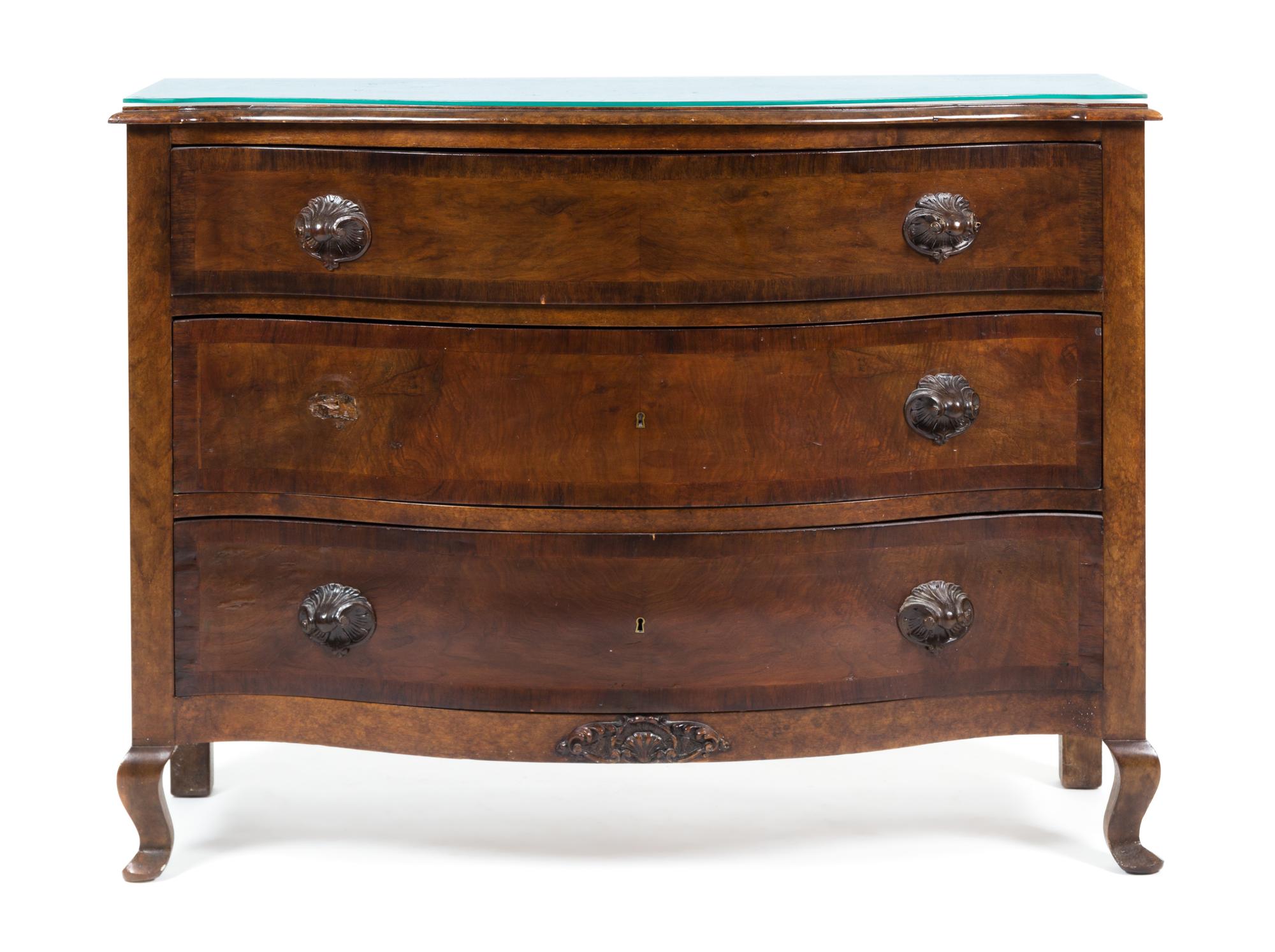 A Continental Walnut Chest of Drawers Height 35 1/2 x width 48 x depth 19 1/2 inches.