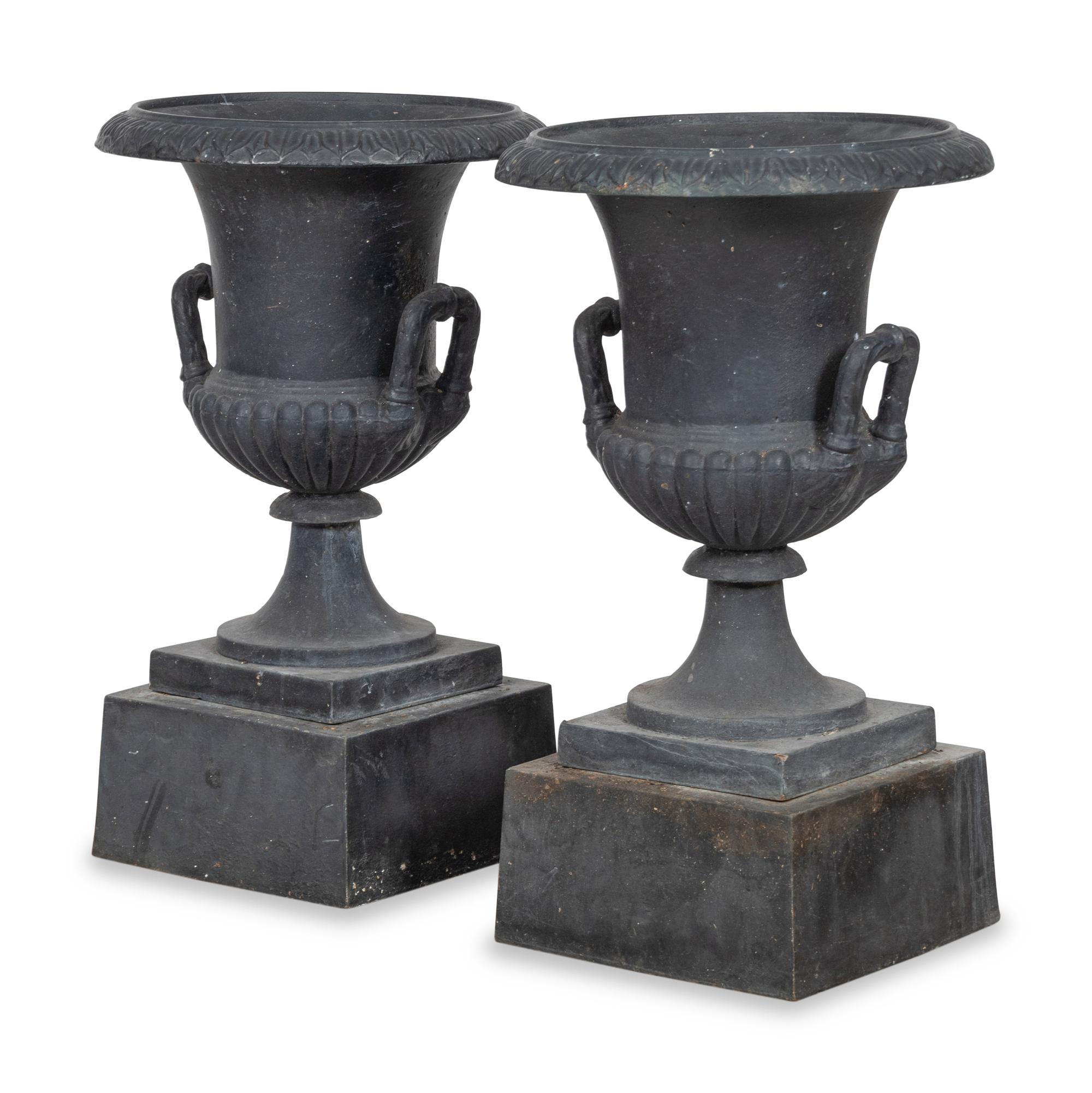 A Pair of Cast Iron Garden Urns and Plinths