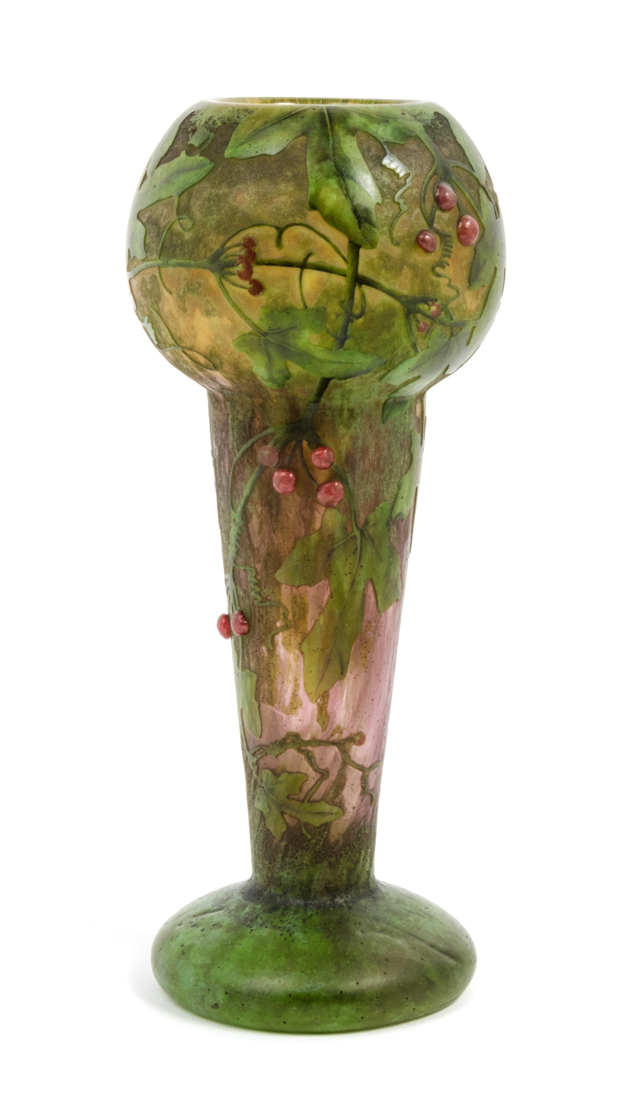 Daum, EARLY 20TH CENTURY, enameled and applied cameo glass vase, of baluster form decorated with berry laden leafy branches,