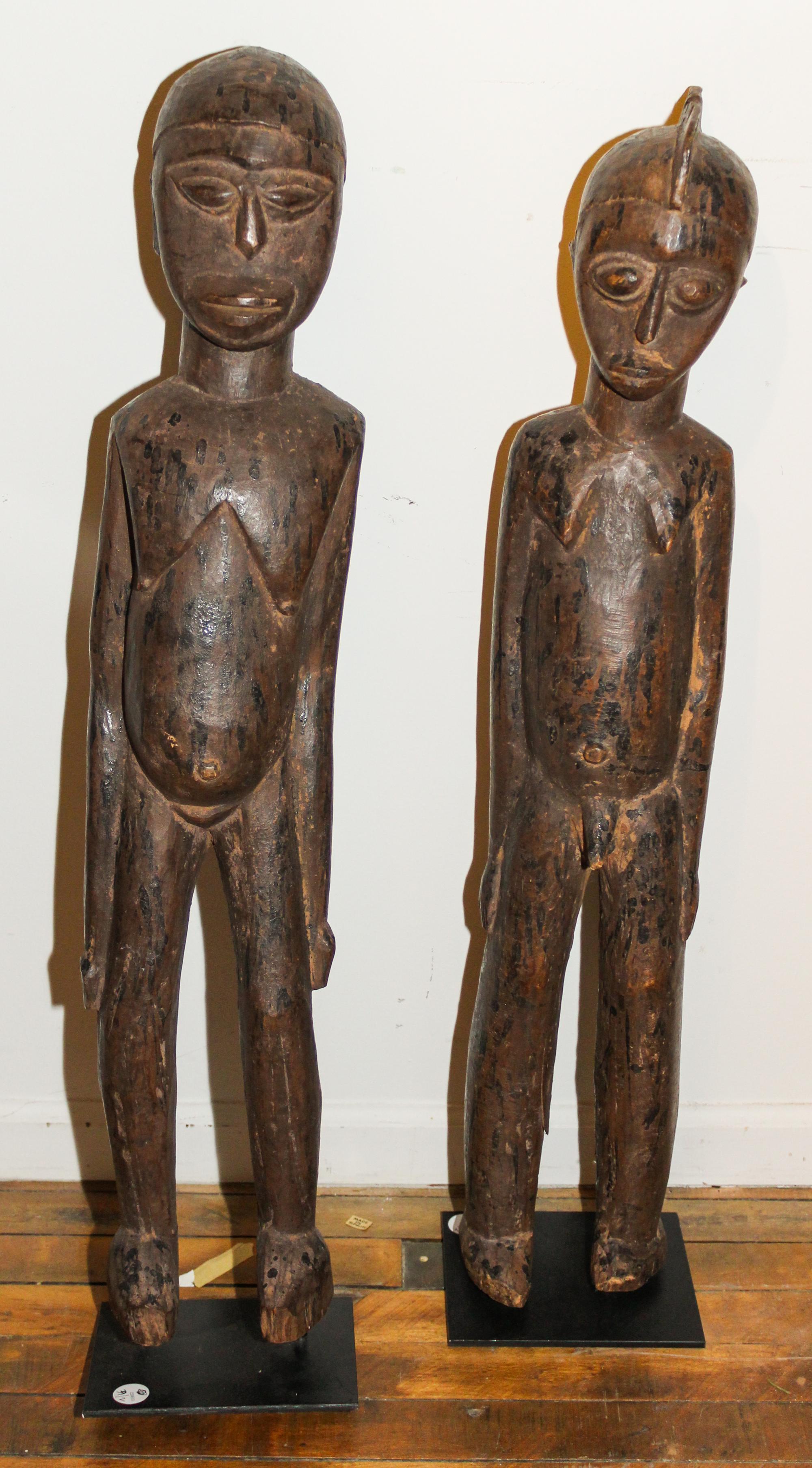An Igbo Carved Wood Couple. Height 34 x width 6 1/2 x depth 5 1/2 inches.
