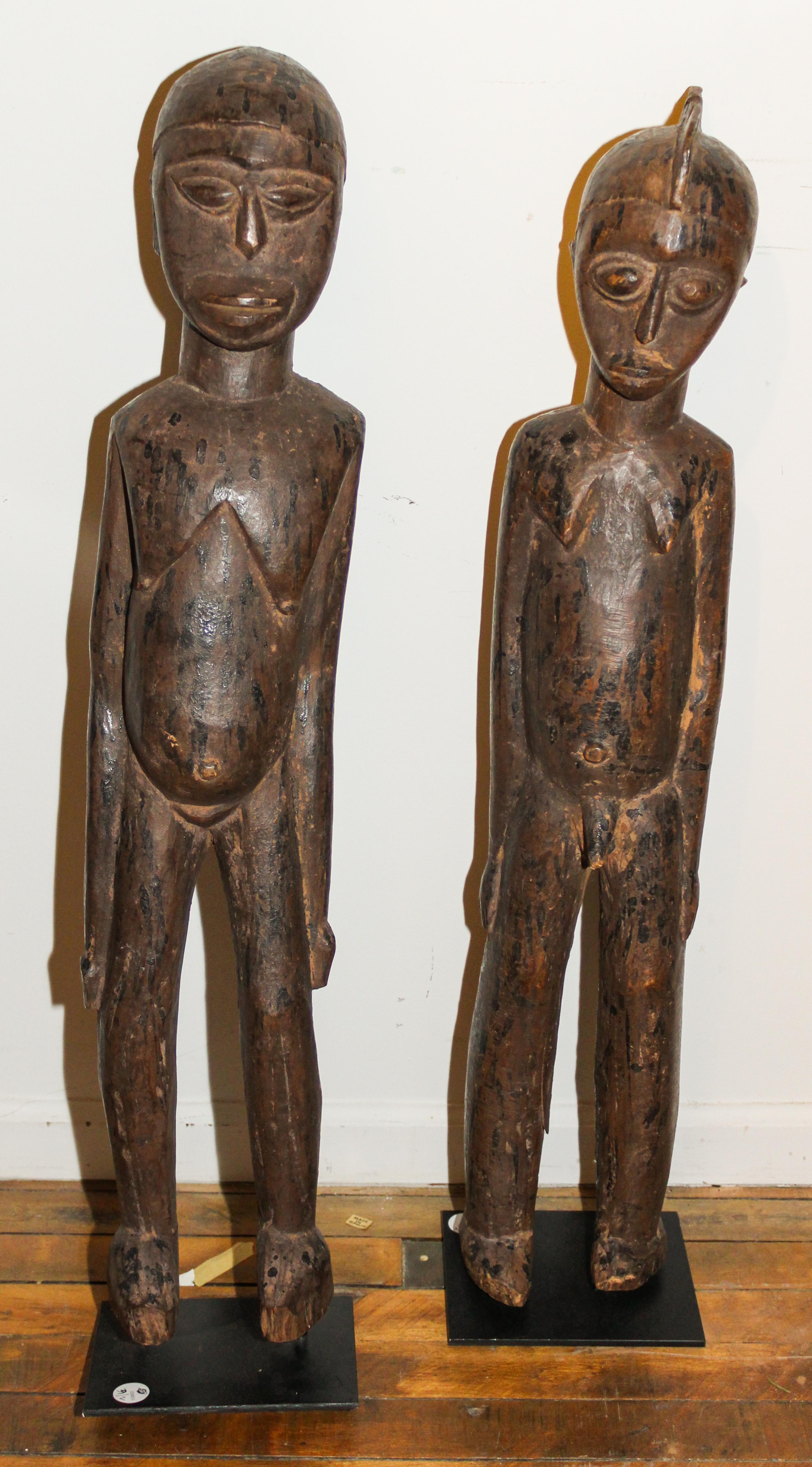 An Igbo Carved Wood Couple. Height 34 x width 6 1/2 x depth 5 1/2 inches.