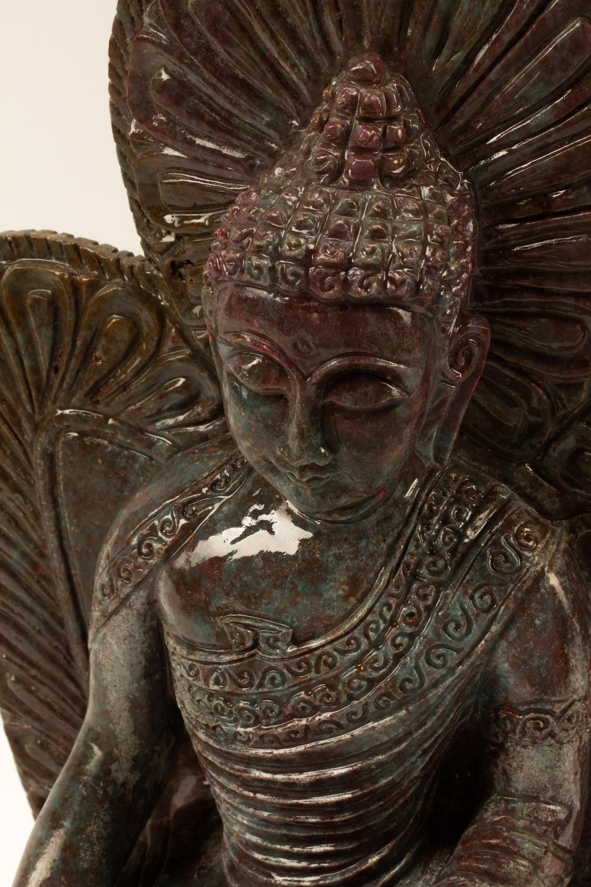A Carved Ruby-Zoisite Figure of a Seated Deity