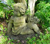A Pair of Cast Stone Seated Putti