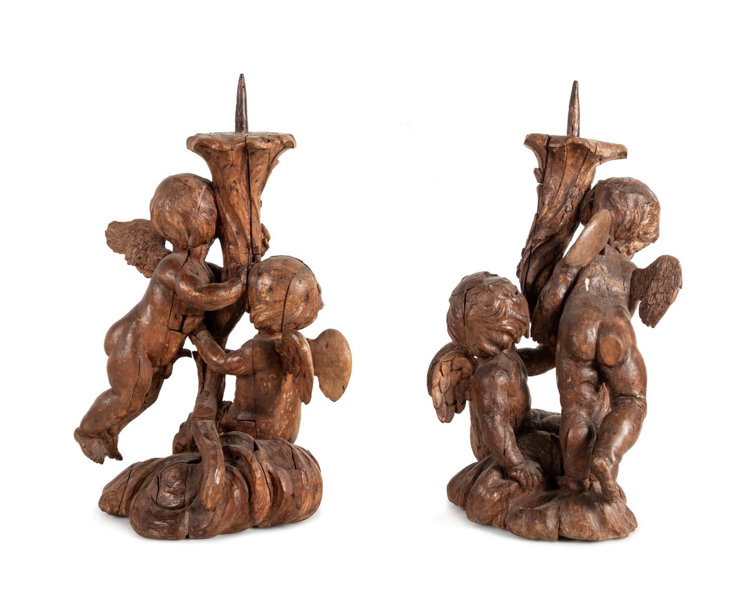 A Pair of Continental Carved Wood Cherubic Prickets