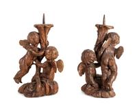 A Pair of Continental Carved Wood Cherubic Prickets