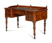A Continental Mahogany Five-Drawer Writing Desk and Associated Regency Chair