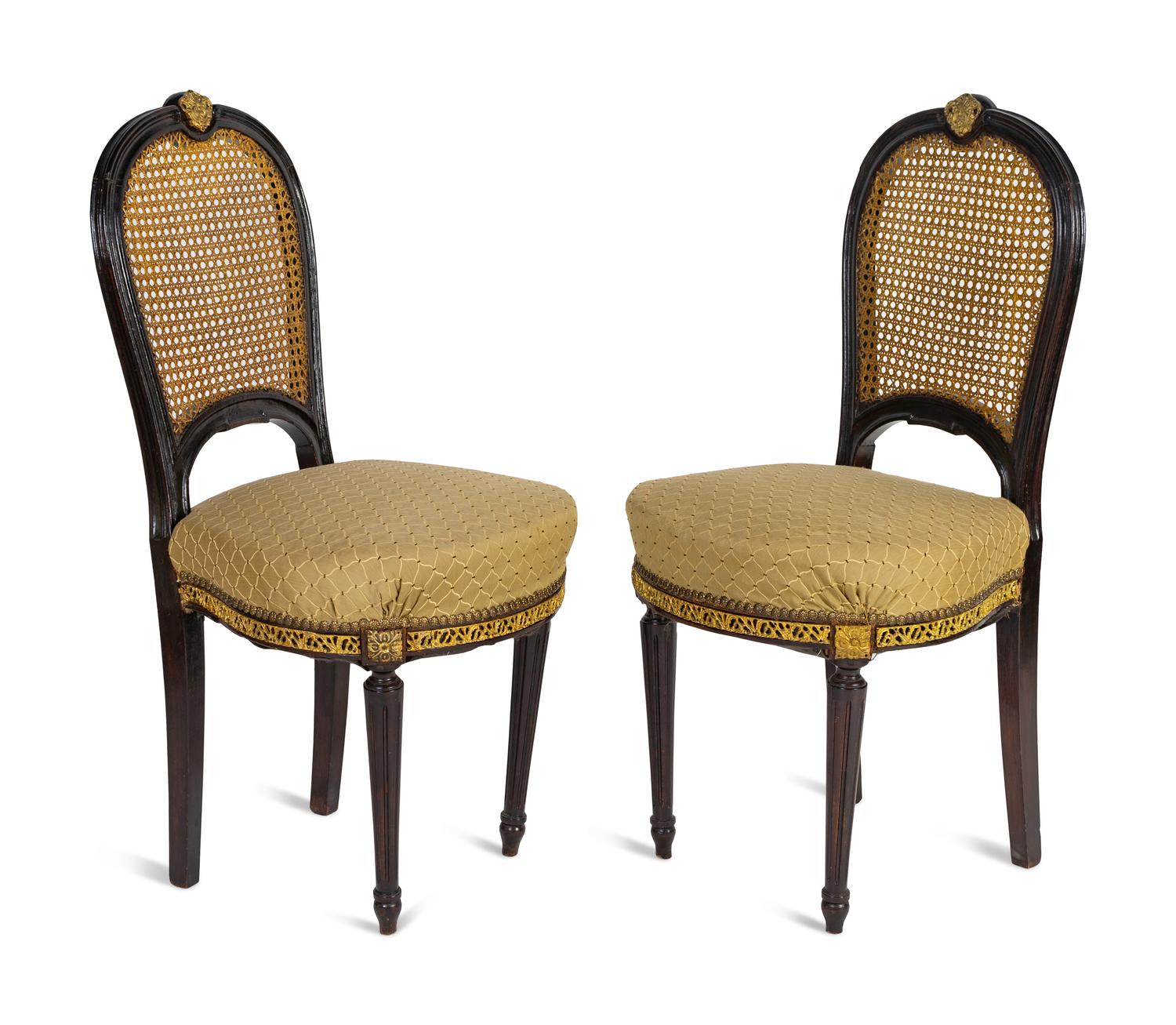 A Pair of Black Painted, Caned and Upholstered Side Chairs Height 37 x width 18 x depth 17 inches.