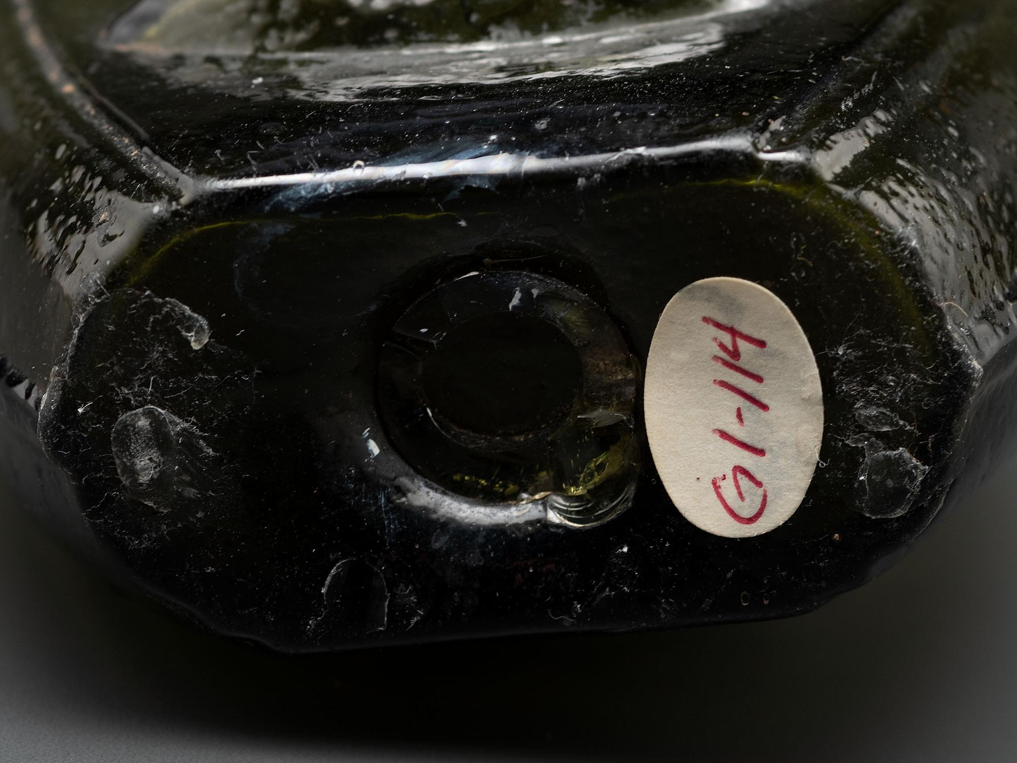 An Olive Green Glass Portrait Bust Flask