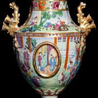 A Pair of Chinese Export Canton Famille Rose Porcelain Covered Urns, Early 19th Century — 清晚期 外銷廣彩人物故事圖獎杯形賞瓶一對