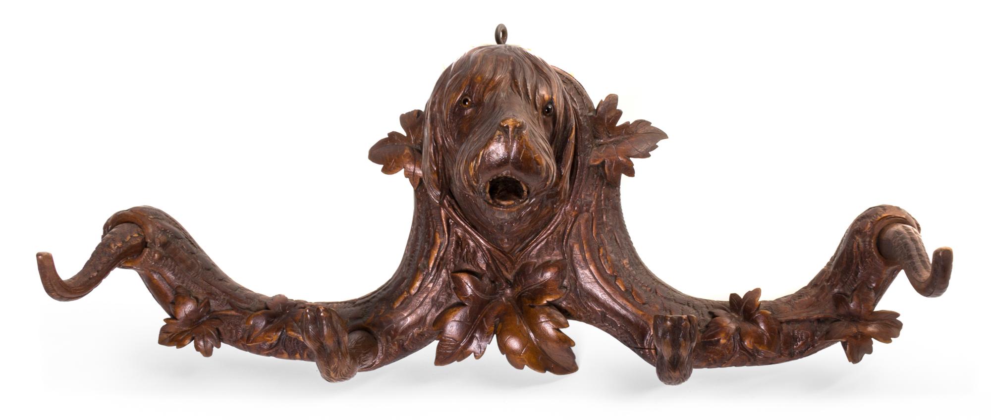 A Black Forest Carved Fruitwood Wall Rack, Width 23 inches.